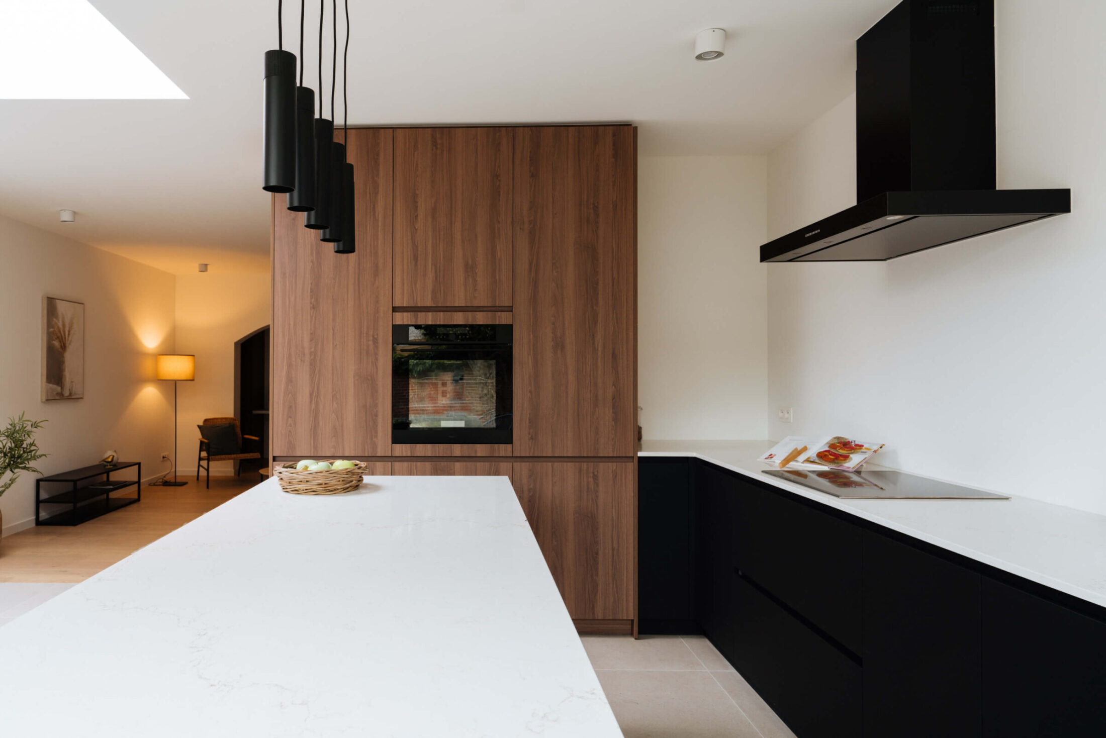 Moderne keuken met wit werkblad, zwarte onderkasten en zwarte wanddampkap, Kaster Keukens